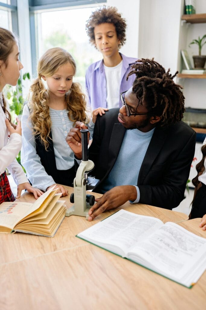 A Teacher Teaching Students about a Microscope